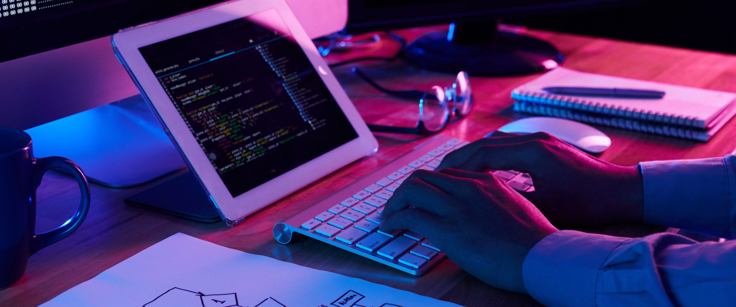 Close-up image of programmer working at his desk in office